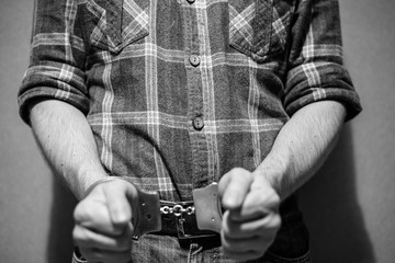 police handcuffs on the hands of a criminal