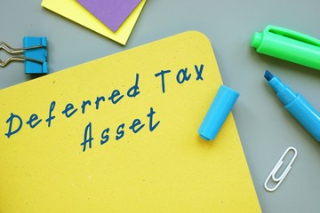 The photo shows Deferred Tax Asset. Notepad, heap, marker.