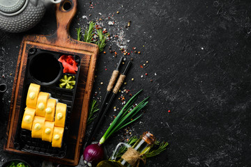 Delivery Japanese food. Sushi rolls with cheese, wasabi and soy sauce in a plastic box. Top view.
