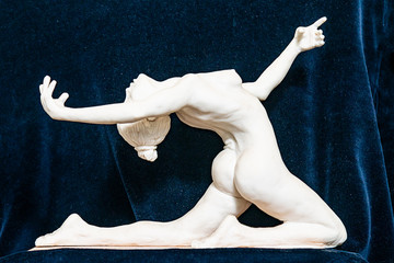 Gypsum sculpture of an unknown girl. The girl makes a gymnastic figure