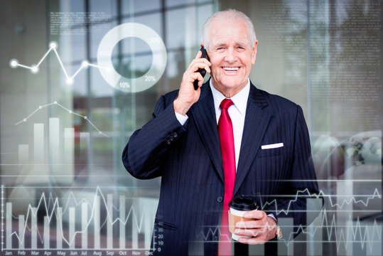 Smiling senior business man looking at camera, calling on smartphone and holding disposable cup. Business communication concept. Front view with virtual analytic diagrams and text samples.