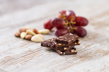Pieces of dark chocolate with almonds and fruits