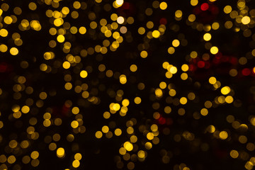 Fototapeta na wymiar Gold and red lights in defocus. Beautiful bokeh for Christmas.
