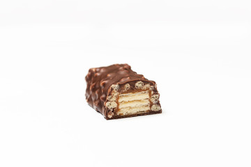 sliced chocolate bar with dark brown chocolate with nuts on a white background.