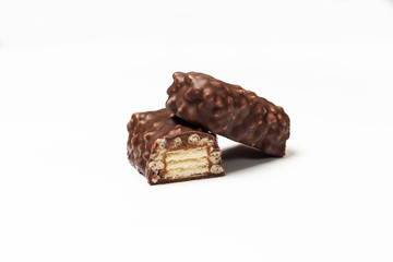 sliced chocolate bar with dark brown chocolate with nuts on a white background.