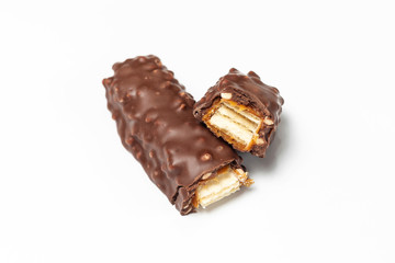 Broken chocolate bar with dark brown chocolate with nuts on a white background.