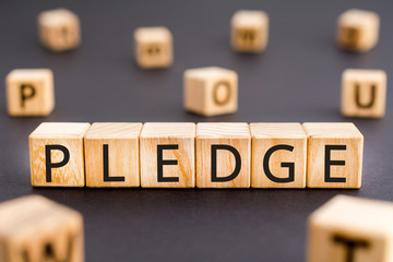 Pledge - word from wooden blocks with letters, deposit, guarantee, bail, promise, pledge concept, random letters around white background