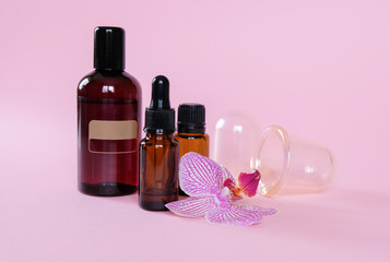 Obraz na płótnie Canvas Essential oils , various bottles aromatherapy on a pink background. Aromatherapy and perfumes concept