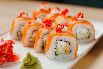 Japanese sushi roll set on delivery in quarantine. Red dragon. Rice, nori, tempura shrimp, tabasco sauce, cucumber, fresh salmon, salmon caviar.