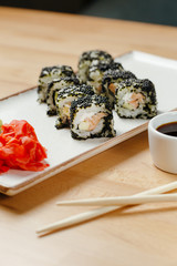 Sushi set roll california salmon. Delivery food on qurantine. Rice, nori, tiger prawn, cucumber, avocado, spice sauce, masago caviar.