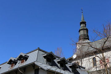 Fototapeta na wymiar Clocher de l'église Saint-Gervais et Protais sur fond de ciel bleu. Saint-Gervais-les-Bains. Haute-Savoie. France.