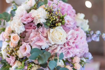 Close up of pink and lilac wedding bouquet. Wedding decoration. Bride's wedding bouquet. Wedding decor at the banquet. Wedding restaurant decorated with flowers. Luxury wedding table decoration.
