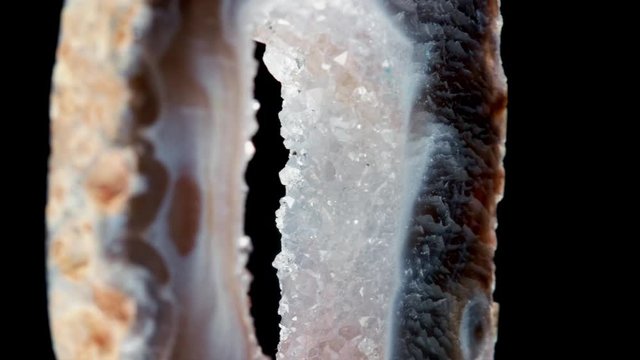 Agate with quartz. Agate rotates around its axis on a black background.