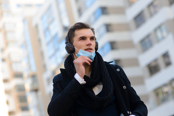 Fototapeta premium People with face mask. Concept with copy space. Portrait of adult man in quarantine of flu. Photo on the street in the city