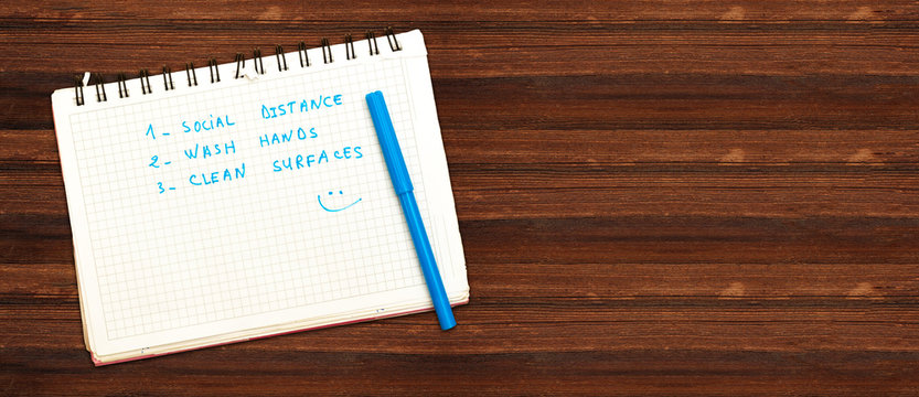 Coronavirus COVID-19 health safety guidelines. notebook with rules, practice social distancing, wash hands, clean surfaces, hand washing, stay home.