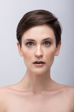 Portrait of a young girl with a long neck, almost no makeup on her face, photo without retouching, natural makeup and vivid emotions, surprise in the look and big eyes