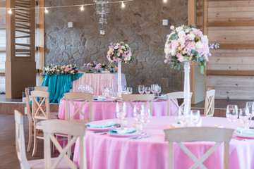 Wedding decor at the banquet. Wedding restaurant decorated with flowers. Luxury wedding table decoration. Special event table set up. Fresh flower decoration.