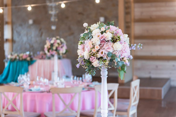 Wedding decor at the banquet. Wedding restaurant decorated with flowers. Luxury wedding table decoration. Special event table set up. Fresh flower decoration.