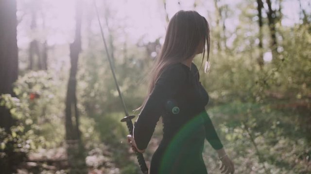 Portrait of a pretty girl with a samurai sword .Girl with a samurai sword fought at sunset.martial arts