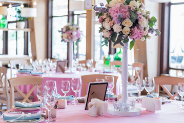Wedding decor at the banquet. Wedding restaurant decorated with flowers. Luxury wedding table decoration. Special event table set up. Fresh flower decoration.