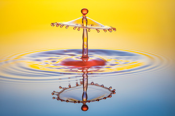 water drop collision on yellow background