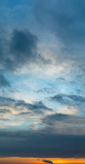 Obraz premium Fantastic clouds at sunrise, vertical panorama