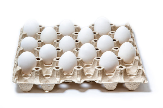 isolated carton box with distanced white eggs. concept of quarantine rules