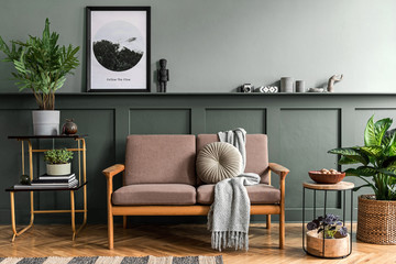 Stylish interior design of living room at cozy apartment with stylish sofa, plants, design...