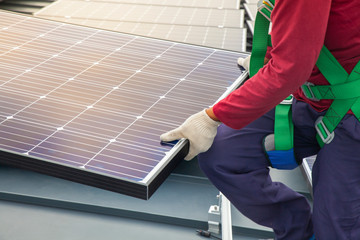 Technician installing solar panels, Renewable energy clean and good environment.