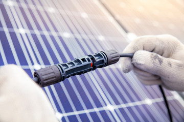 Technician Connecting the electric wire from solar panels generate, Renewable energy clean and good...