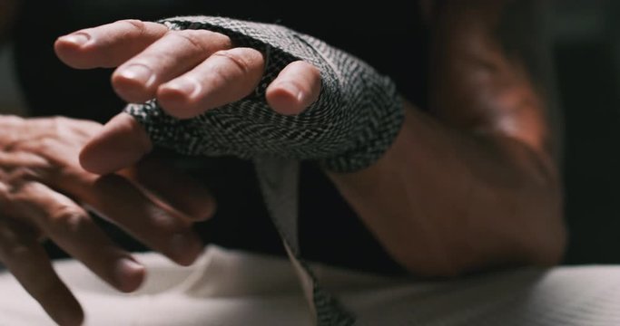 Close up of fighter's wrist being wrapped.