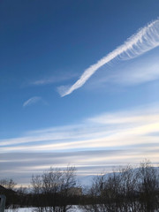 beautiful blue sunset sky with feather clouds over the mountains
