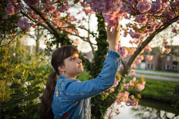 Portrait of caucasian girl in blossom of sakura