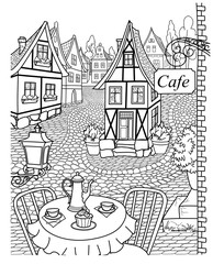 Obraz premium Cozy street with cobblestone pavement, lovely houses and cafe.