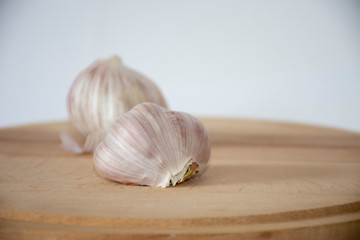 Garlic on a wooden board with a white background