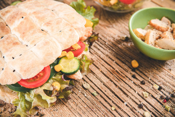 Delicious sandwich on wooden table. Tasty fast food