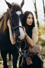 Young woman with her horse in country club. Ranch style