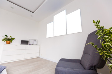 Mockup photo canvas in interior. Empty canvas for design. White brick wall on background.