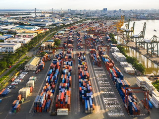 Logistics and transportation of Container Cargo ship and Cargo plane with working crane bridge in shipyard, logistic import export and transport industry background, Ho Chi Minh city, Vietnam