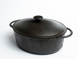 Cast iron pot for stewing, baking with a lid. White isolate