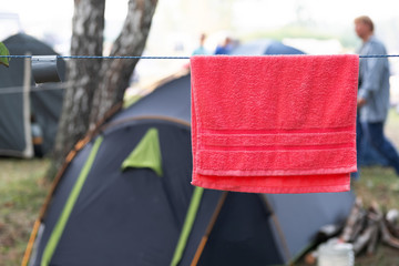 red towel on a rope near the tents