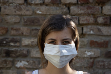 Woman protecting herself wearing a face mask
