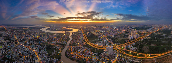 Top view aerial of Mai Chi Tho road, Thu Thiem peninsula and center Ho Chi Minh City, Vietnam  with development buildings, transportation, energy power infrastructure. View from District 2