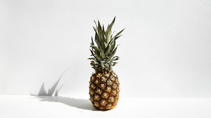 
Summer tropical fruits. One whole pineapple on a white background.