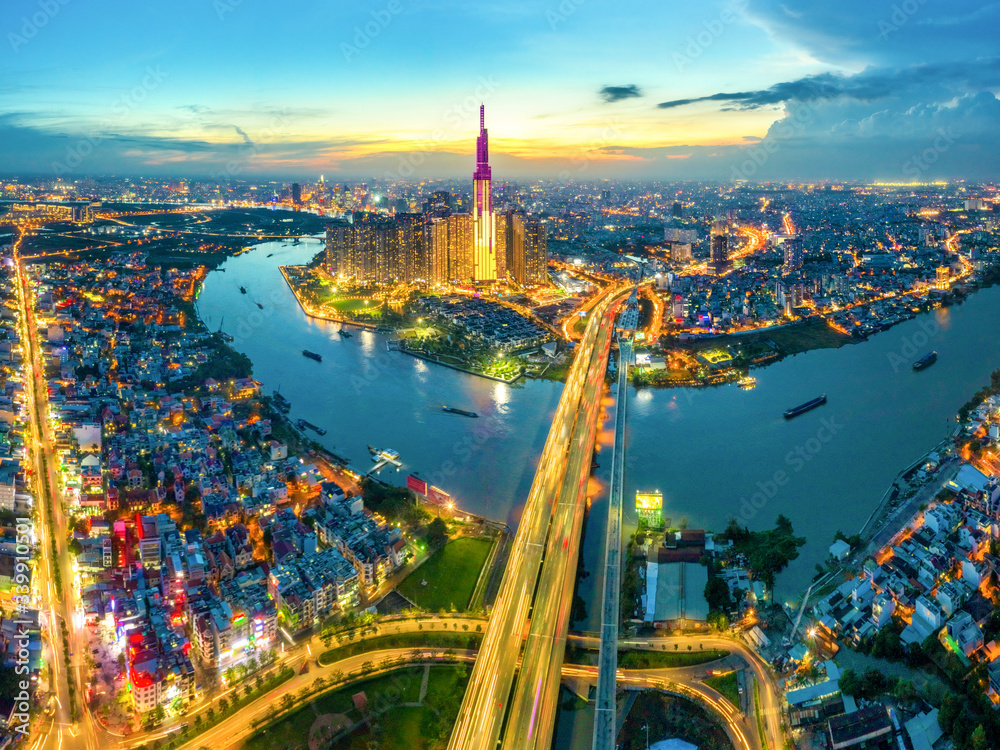 Wall mural Top view aerial of center Ho Chi Minh City and Saigon bridge with development buildings, transportation, energy power infrastructure. Financial and business centers in  Vietnam. View from District 2