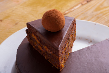 Slice of gluten free chocolate cake with truffle above