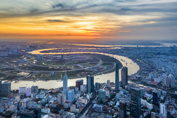 Naklejka na ściany i meble Top view aerial of Thu Thiem peninsula and center Ho Chi Minh City with development buildings, transportation, energy power infrastructure. Financial and business centers in developed Vietnam