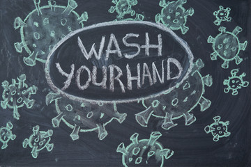 Fototapeta na wymiar Wash your hand. Outbreak Warning. written white chalk on blackboard in connection with epidemic of coronavirus worldwide.