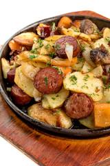 fried potatoes with sausages isolate on a white background