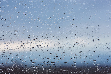 Drops of rain on the window. Water on the glass. Running drops. Background conceptual.
